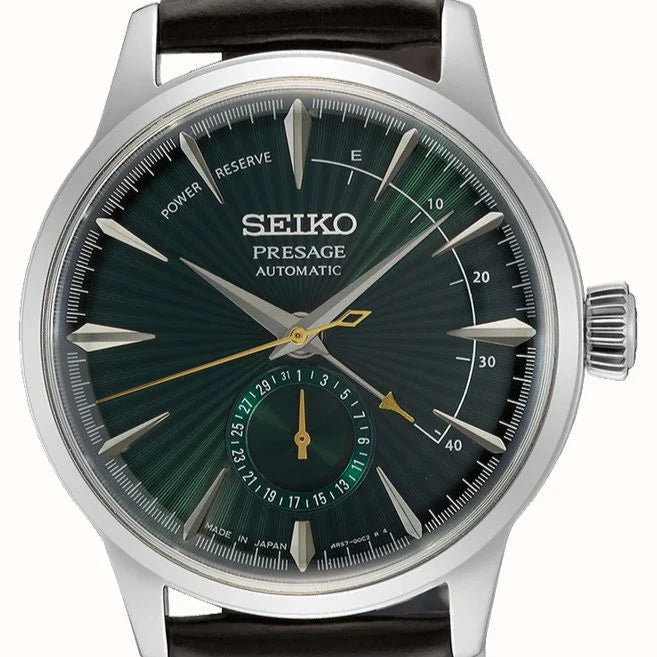 Seiko Presage watch with green face and brown leather strap on white background