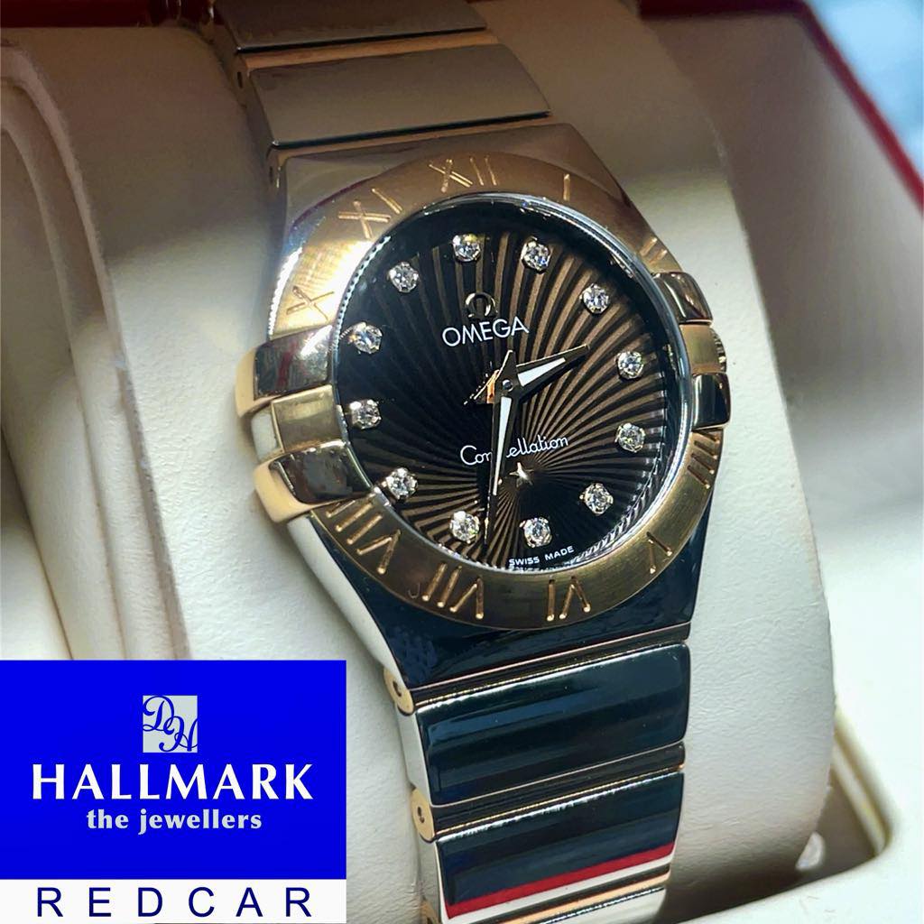 Luxury watch with diamond accents on a white cushion Omega Constellation