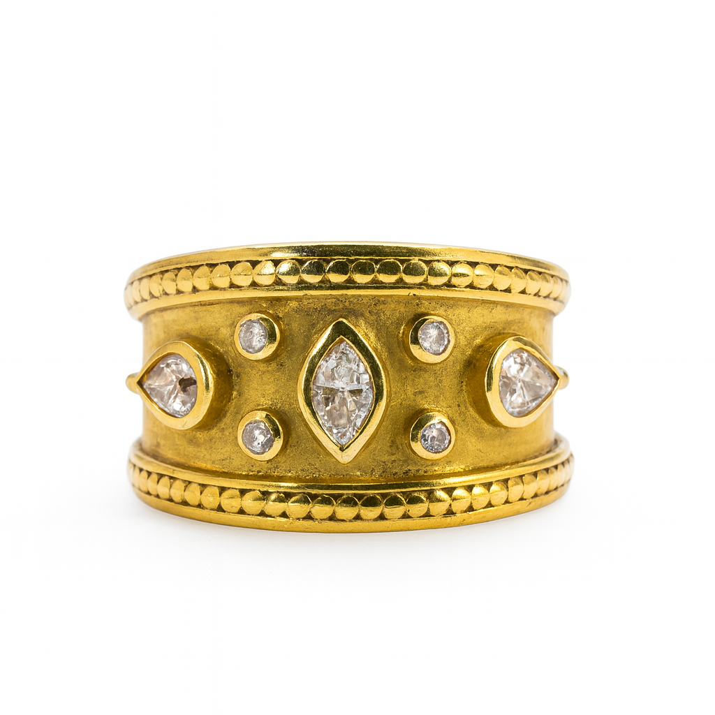 Gold ring with diamond-like stones on a white background