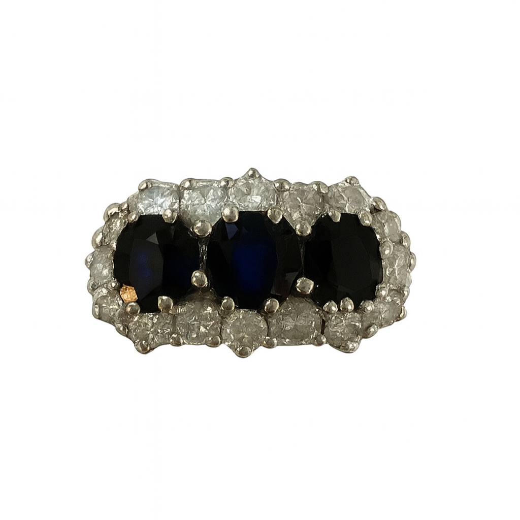 Ring with three dark gemstones and diamond-studded band qualified gemmologist