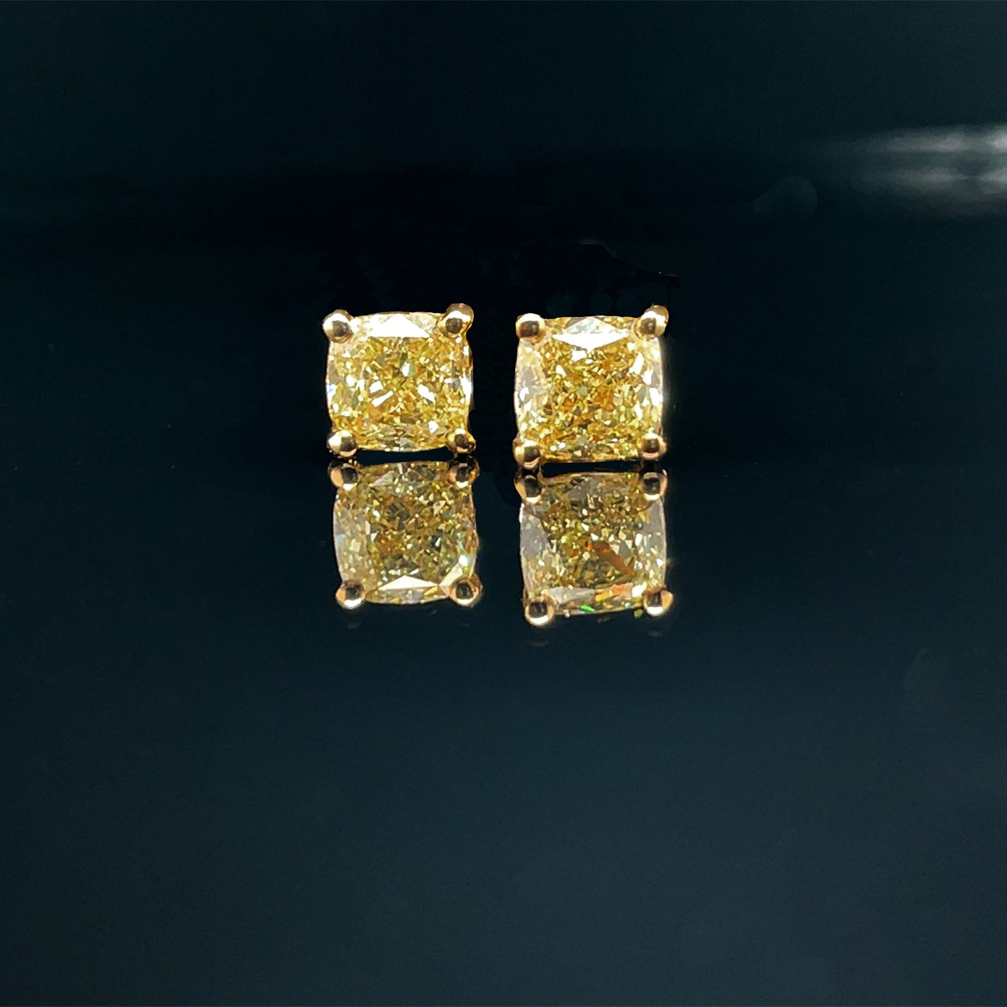 Cushion cut yellow diamond stud earings