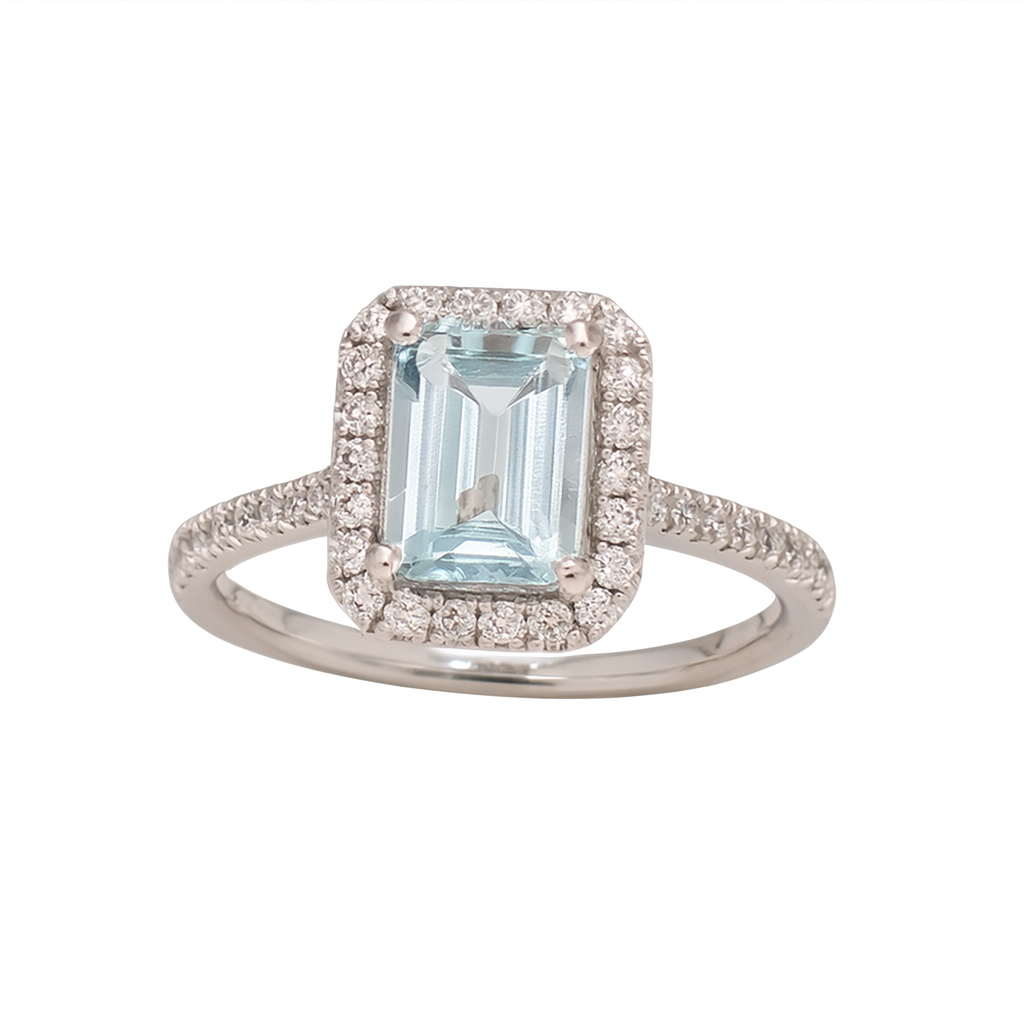 Ring with emerald-cut gemstone and diamond accents on a white background