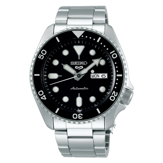 Seiko watch with black dial and silver metal strap on a white background