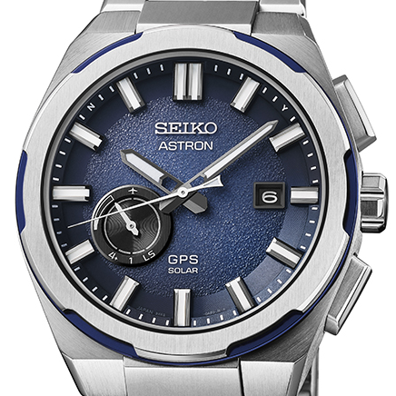 Seiko Astron watch with blue dial and silver case on a white background